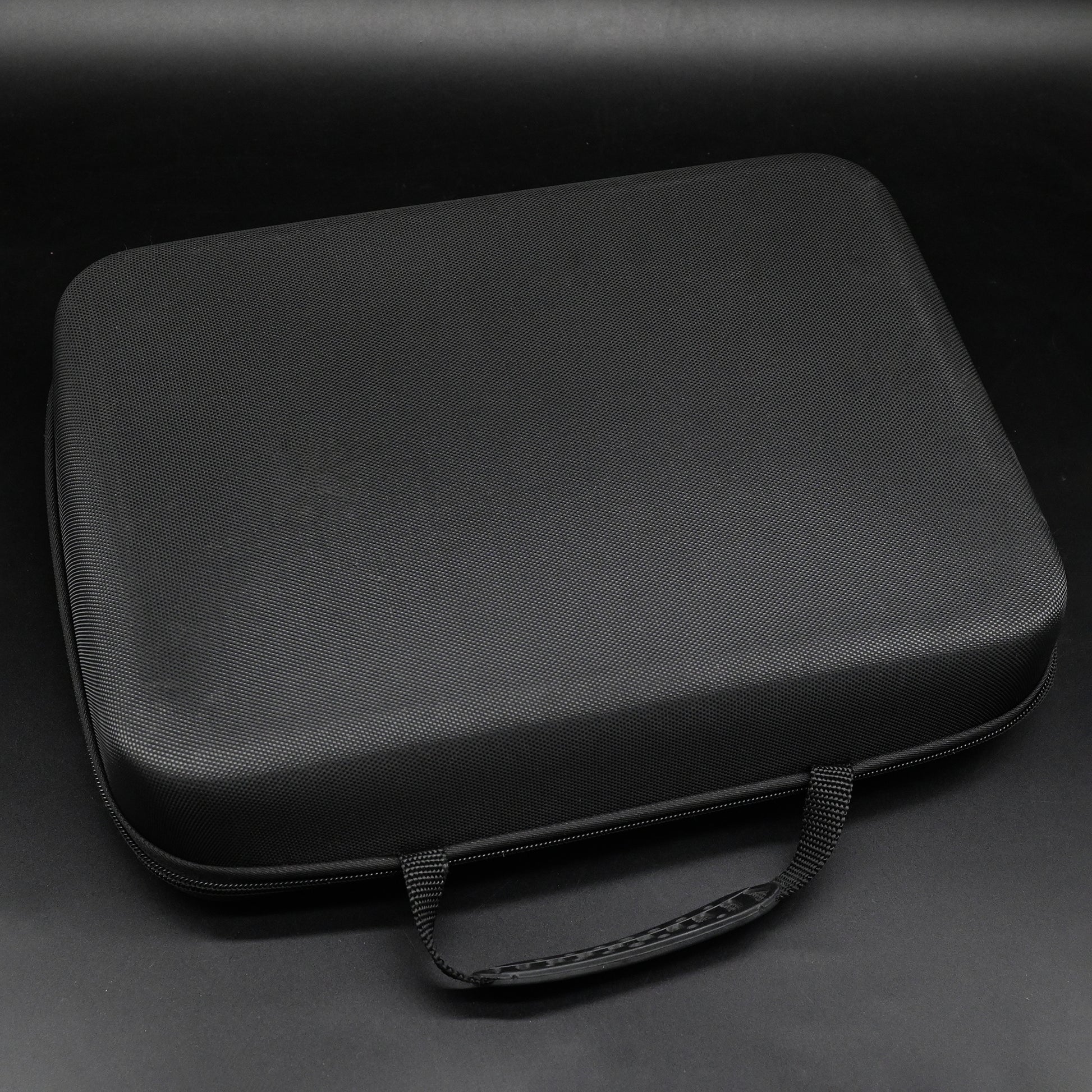 Black carrying case on a dark gray background