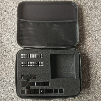 Black carrying case with dice and measuring gauges  with storage compartments 