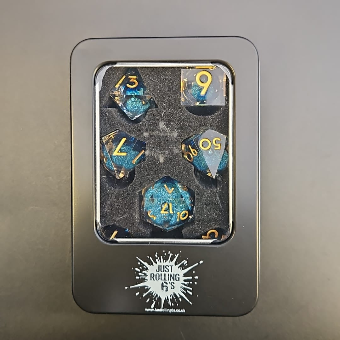 Clear & Blue Glitter 7 Piece Liquid Core Dice Set with Gold Numbering and highlights, in Metal Box