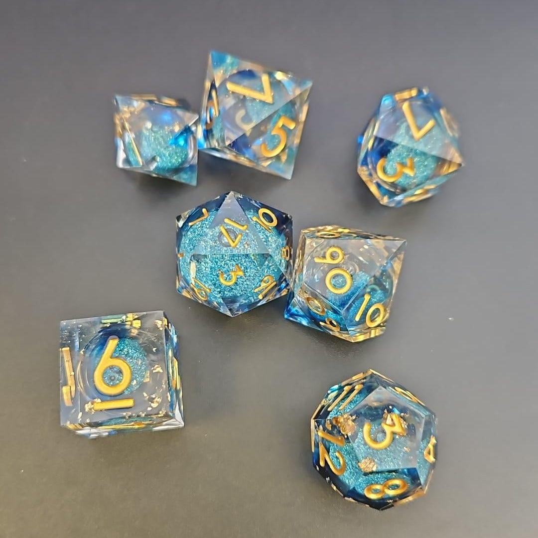 Clear & Blue Glitter 7 Piece Liquid Core Dice Set with Gold Numbering and highlights, in Metal Box