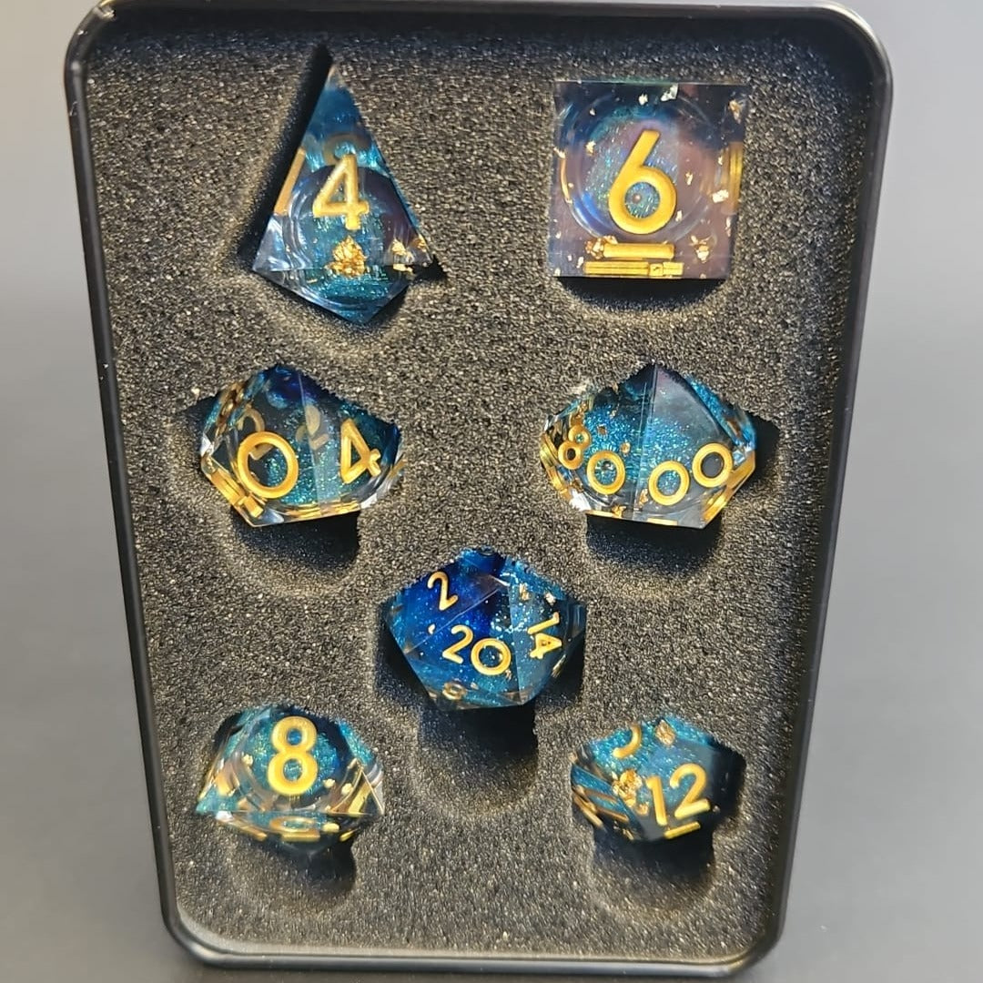 Clear & Blue Glitter 7 Piece Liquid Core Dice Set with Gold Numbering and highlights, in Metal Box