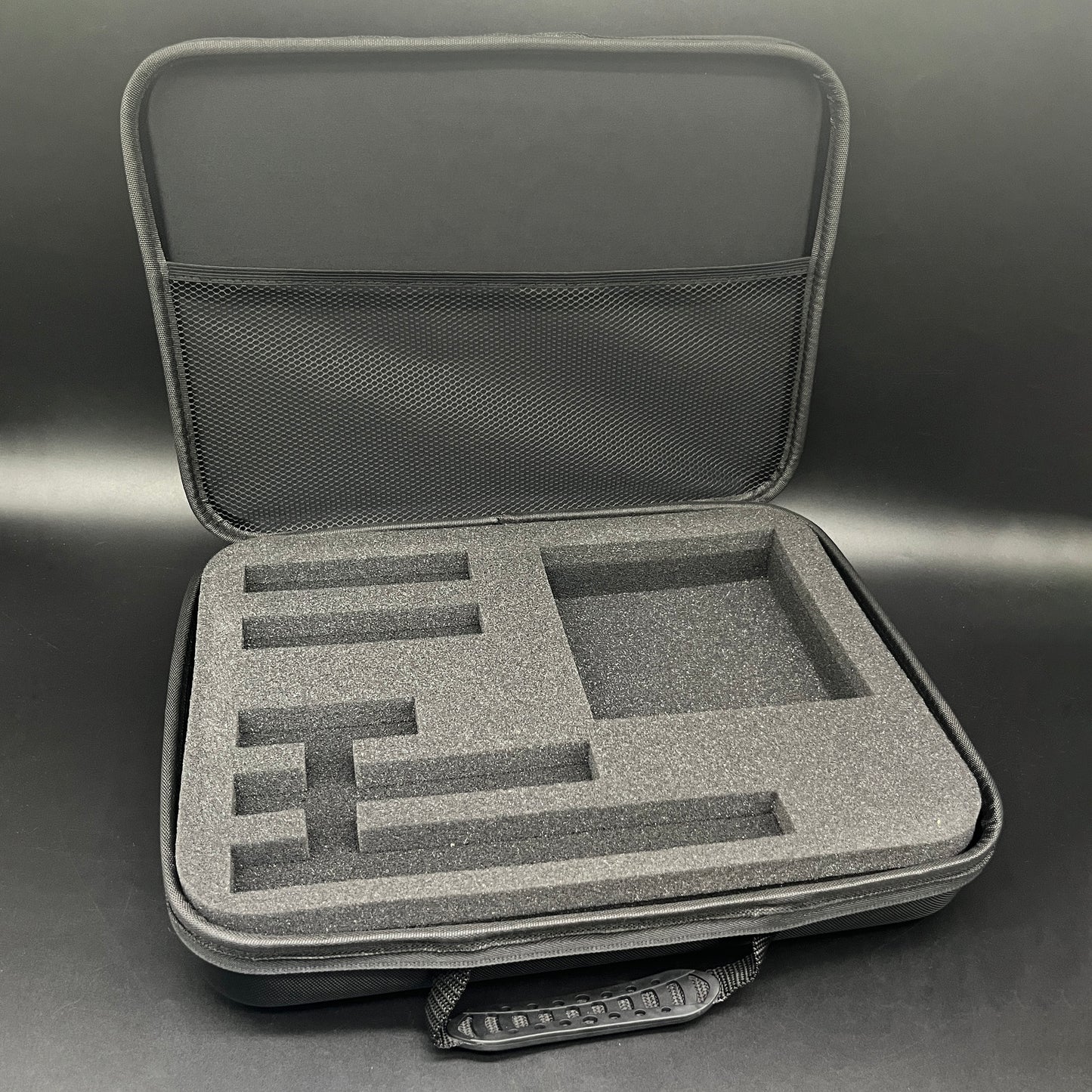 Gray hard-shell carrying case with foam interior on a gray background