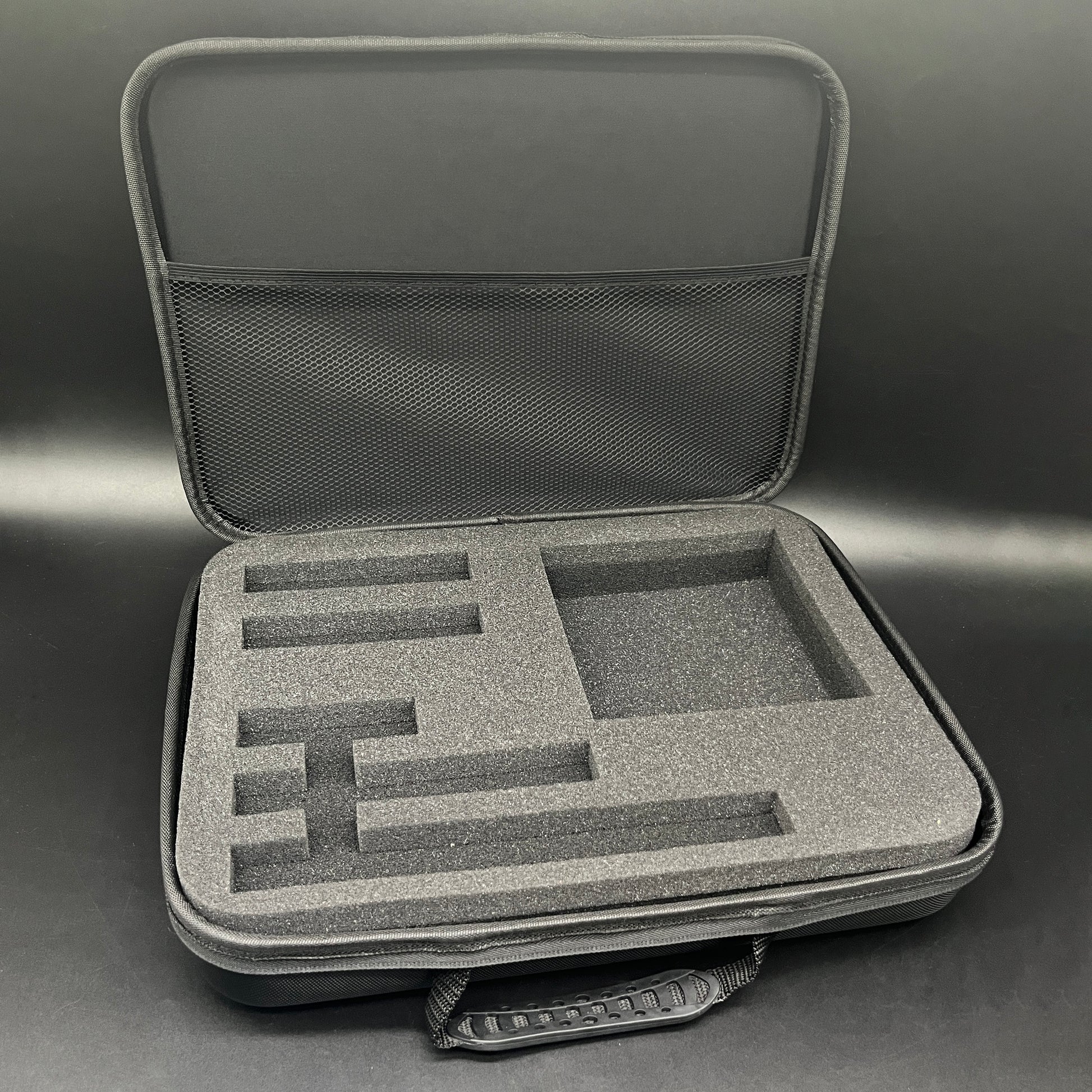 Gray hard-shell carrying case with foam interior on a gray background